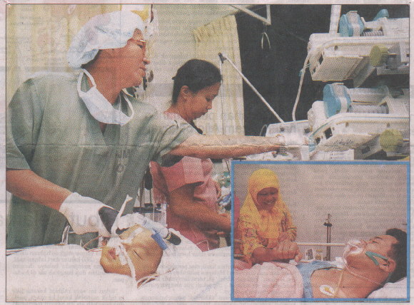 Bobby attending to Afiq, the liver transplant recipient, in ICU